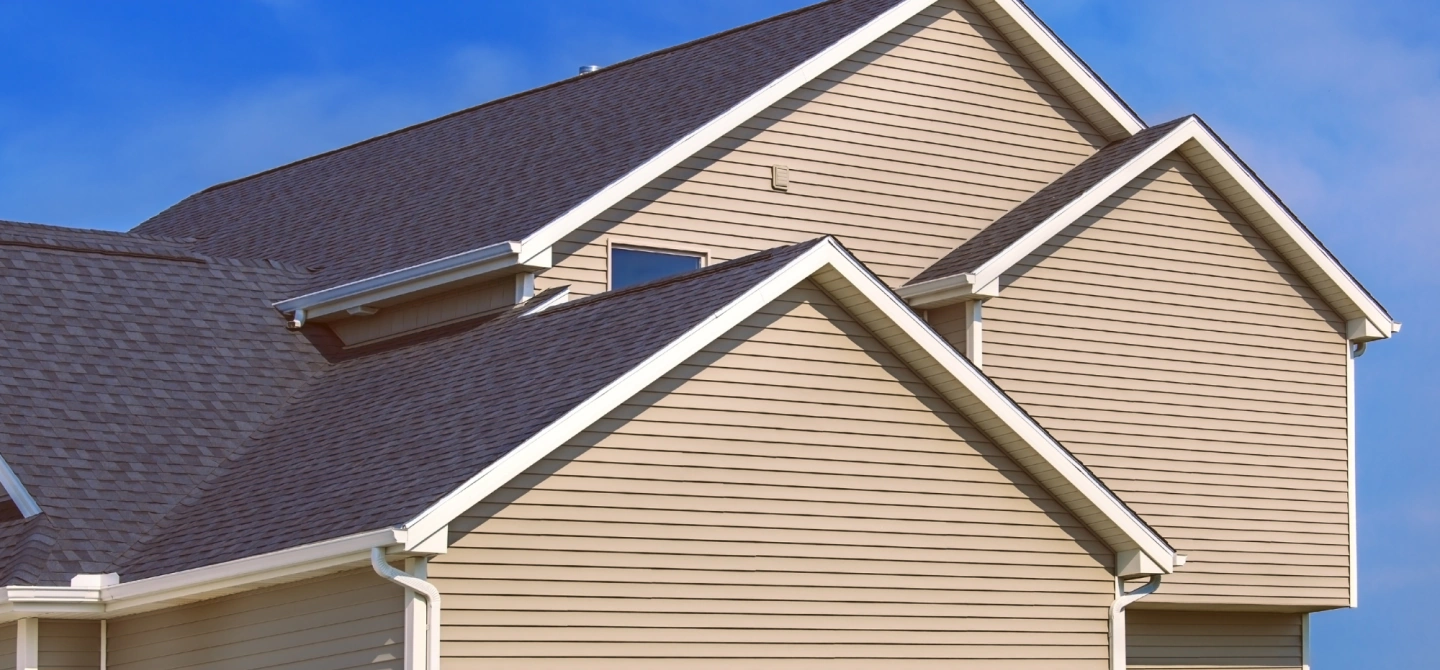 beige siding of a house with light brown roofing