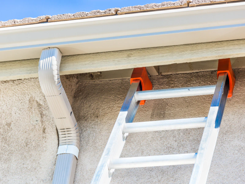 ladder next to a gutter during replacement